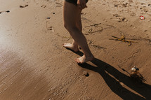 barefoot on a beach 