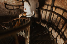 a man walking down an iron staircase 