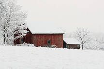 a barn covered in snow 