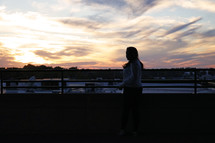 a silhouette of a girl at sunset 