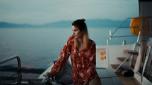 a woman on a yacht looking out at water 