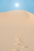 footprints in a sand dune 