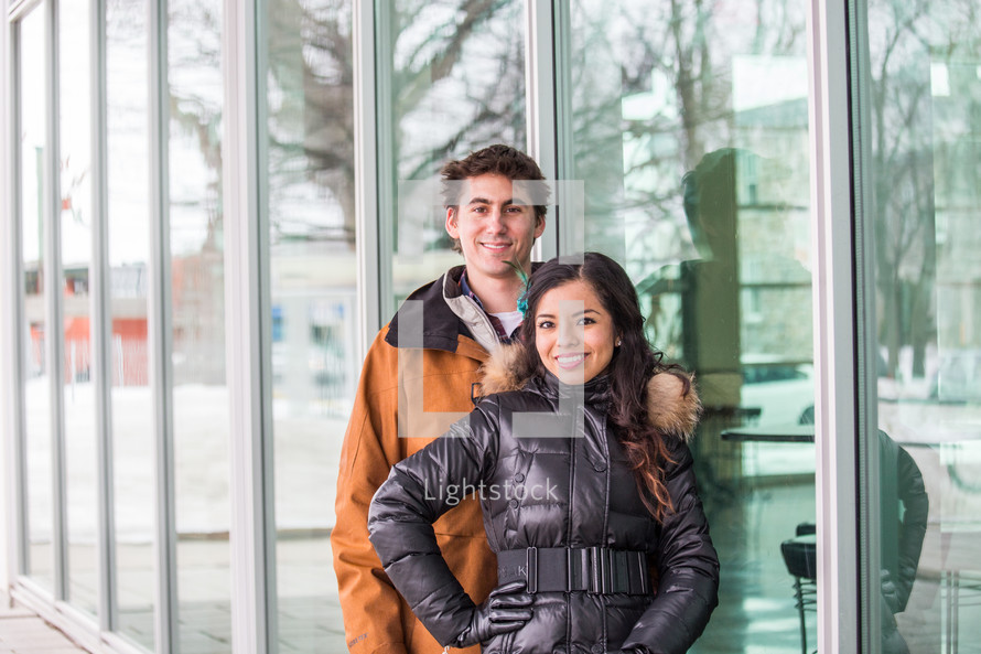 portrait of a couple in front of shop windows 