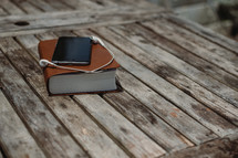 smartphone, earbuds, and a Bible 