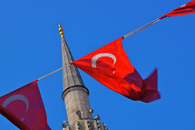 Turkish flags hanging near a mosque