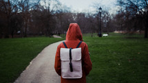 person with a backpack and rain jacket 