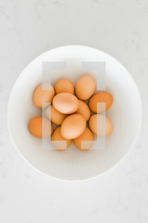 brown eggs in a white bowl 