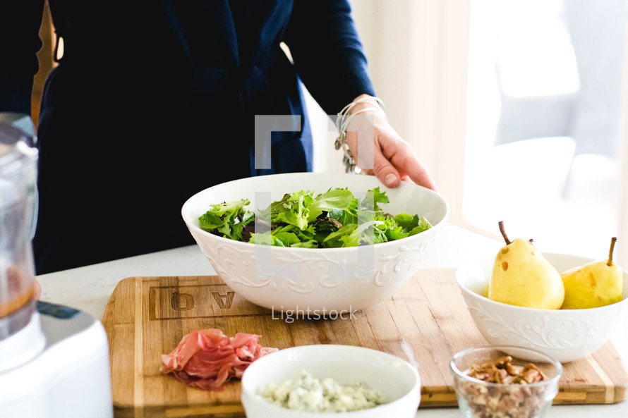a woman preparing a salad 