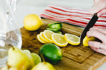 slicing lemons and limes in the kitchen 