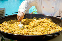 Cooking paella at an outdoor restaurant for a wedding banquet.