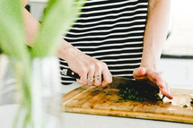 chopping cilantro in a kitchen 