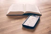 smartphone and an opened Bible 
