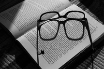 glasses on the pages of a book 