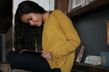 a young woman reading a book 