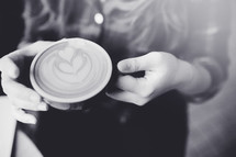 woman holding a coffee latte 