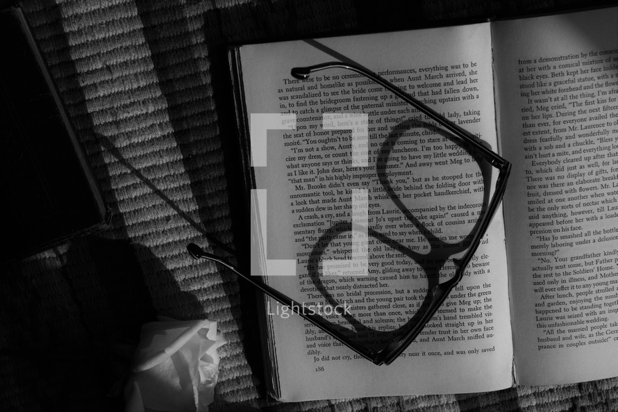 reading glasses on the pages of a book 