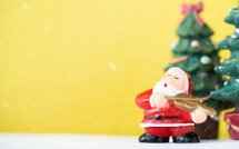 Santa figurine on a yellow background 