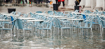 empty Tables and chairs with high water in Saint Mark's square, Venice, Italy.