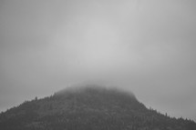 a mountain peak in the clouds 