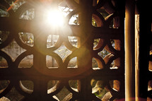 sunlight peeking through a lattice window