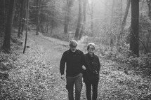 couple walking arm and arm on a trail 