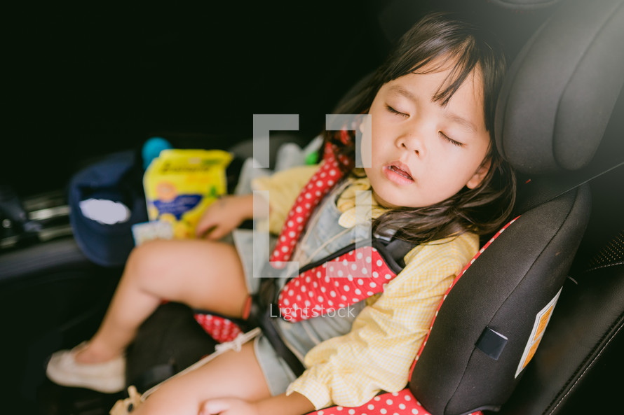 sleeping child in a carseat 