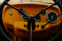 Close up of an old tractor steering wheel.