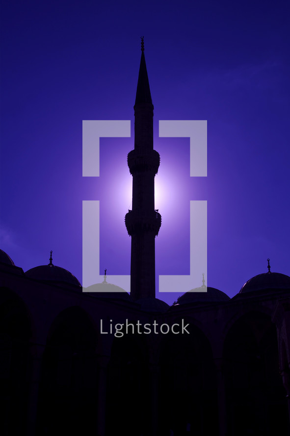 silhouette of a tower on a mosque