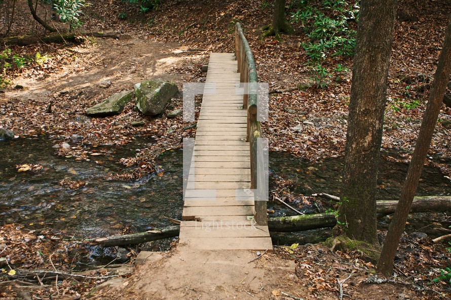 wood bridge over a stream