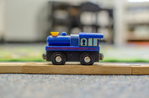 a toy train on a wooden track 