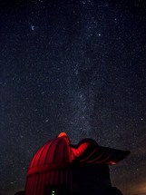 Observatory telescope under stars in the night sky