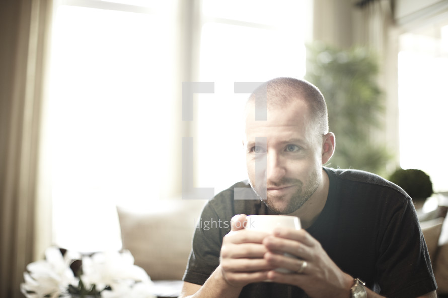 A man holding a cup of coffee