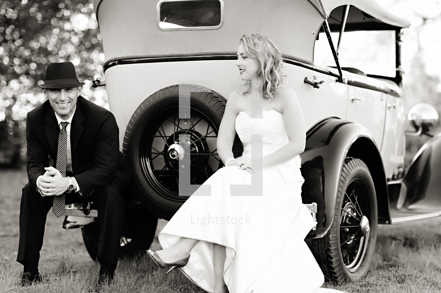 Bride and groom sitting on a vintage classic ford model T car 1920's