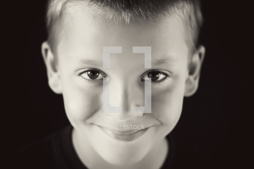 A headshot of a little boy smiling