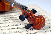 violin scroll and sheet music 