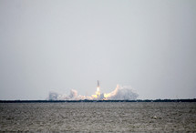 A distant view of a space shuttle launch.
