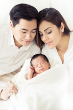 Couple with their newborn infant.