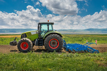 Tractor cultivating the land