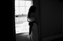 bride standing at a window
