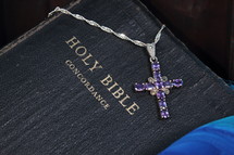jeweled cross lying on a Bible