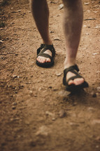 feet on a dirt path 
