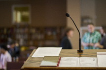 tablet and open Book on a podium 