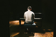 man playing a piano on stage 