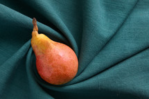 Pear on turquoise cloth