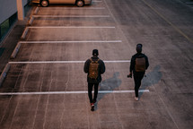 men walking in a parking deck 