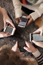 Hands texting on smart phones.