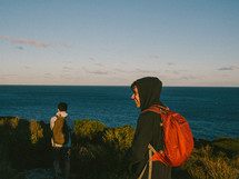 teen boys hiking along a coastline 