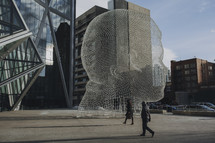 head shaped sculpture in a city 