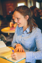 Smiling woman at a Bible study.