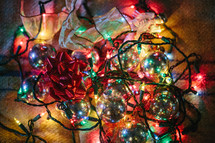 Christmas chaos - pile of ornaments, ribbons, and lights 
